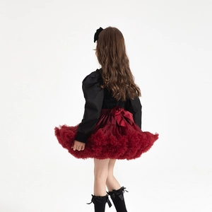 Rear view of girls wine red tiered tutu skirt with a large bow and black puff sleeve top