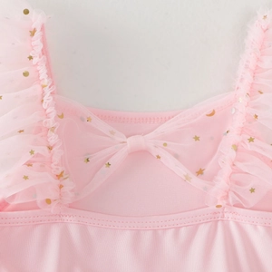 Close-up of pink girls dance dress neckline with mesh bow and gold star sequins