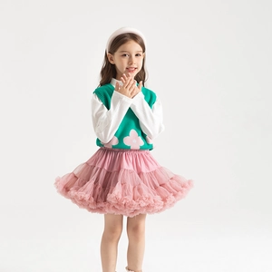 Detail of pink multi-layered tulle tutu skirt showing voluminous mesh texture and soft finish