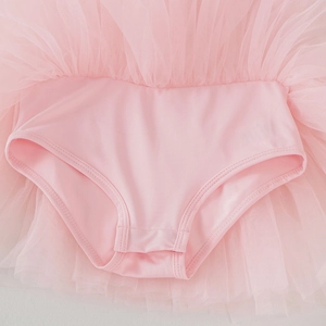 Detail of pink ballet tutu leotard showing multilayer mesh skirt and elastic bottom seam