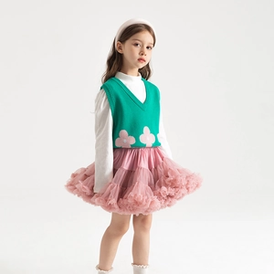 Detail of pink multi-layer tutu skirt paired with a green floral knitted vest outfit