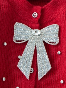 Girls red knit sweater with a luxury oversized rhinestone bow and metal logo buttons