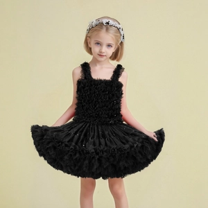 Close-up of girls' black tiered starry mesh tutu skirt with shimmering sequins and lace headband