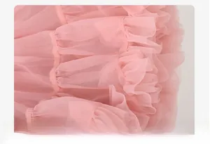 Detailed view of layered pink soft tulle fabric showing ruffles and mesh texture