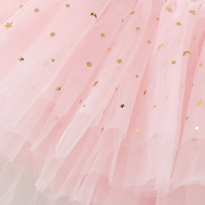 Detail of pink ballet tutu fabric featuring gold star and moon foil print patterns