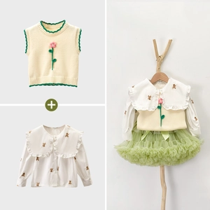 Dettaglio completo di gilet in maglia floreale, camicia con orsetti e gonna tutu verde
