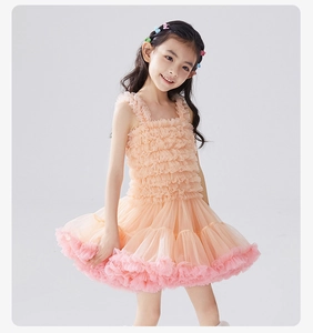 Detail of the layered orange-pink tutu dress with ruffled bodice and puffy mesh skirt