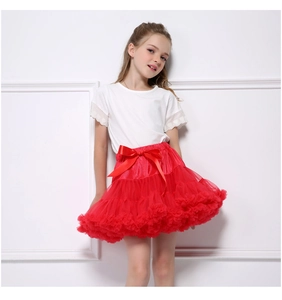 Detail of multi-layered red tulle tutu skirt for girls with a satin silk bow at waist