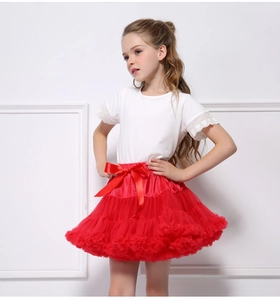 Close-up of girls red layered mesh tutu skirt with a large satin bow and lace t-shirt