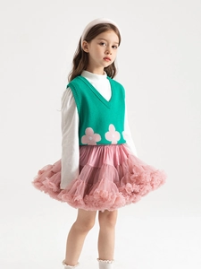 Three-piece girls outfit with green knit vest, white shirt, and pink layered tutu skirt