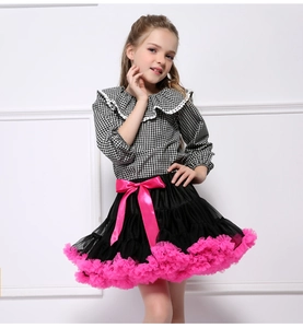 Detail of checkered shirt with lace collar and black tutu skirt with pink ribbon bow