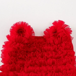 Detail of red tiered tulle dress with shiny sequins and cute ear-shaped ruffles