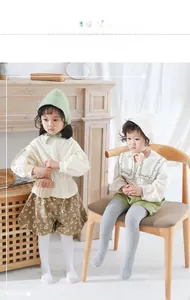 Detailed knit texture of children's ribbed leggings in white and grey cotton fabric