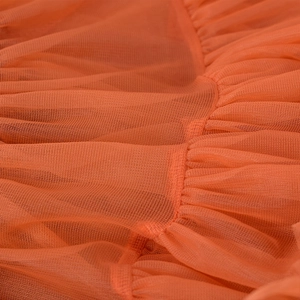 Orange mesh tutu skirt for girls with detailed translucent mesh texture and ruffles