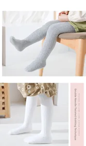 Detail of grey and white cable knit leggings showing double-needle texture for girls