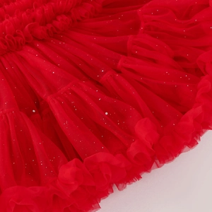Detail view of red tutu skirt featuring multi-layered mesh fabric and silver sequins