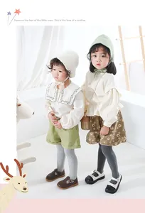 Close-up of girls knitted leggings in dark and light grey for stylish children outfits