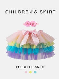 Colorful tiered rainbow tutu skirt with a matching floral headband for toddlers