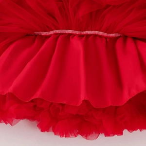 Detailed close-up of vibrant red layered mesh tutu skirt showing fine sewing craftsmanship