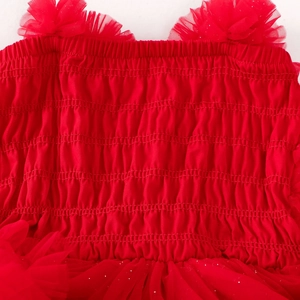 Detail of red tutu dress featuring elastic smocked bodice and sequined mesh skirt