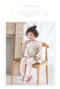 Detail of soft combed cotton pink tights paired with a floral dress and pink shoes
