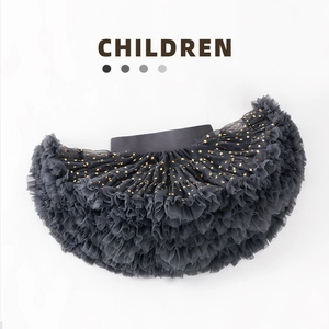 Detailed view of dark grey tutu skirt featuring golden stars and layered mesh fabric