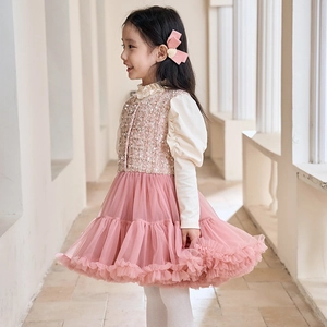 Detailed close-up of pink sequin tweed vest with layered mesh skirt and frill details