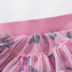 Close-up of pink layered mesh tutu skirt with colorful floral prints and elastic waistband