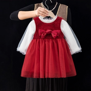 Close-up of red sequin bodice with large bow and white mesh sleeves on girl's party dress