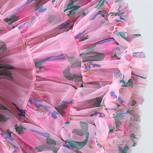 Close-up of pink layered mesh tutu skirt with colorful prints and ruffled details