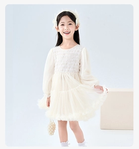 Detail of girls beige lace princess dress with fluffy layered tulle and elegant texture