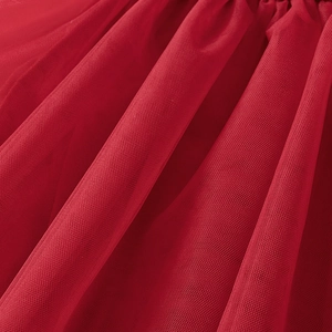 Detailed view of layered red mesh fabric with fine pleats for girls' cotton tops