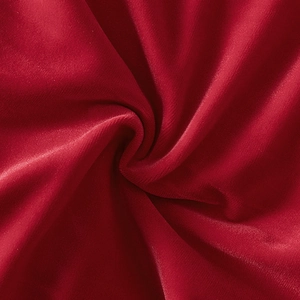 Close-up of premium red velvet fabric with soft texture and elegant pleated highlights