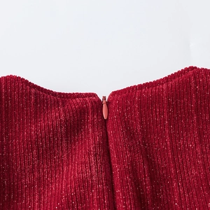 Macro detail of dark red corduroy fabric with silver glitter silk and invisible zipper