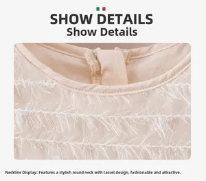 Detail of round neckline with delicate white fringe tassels on a beige mesh dress