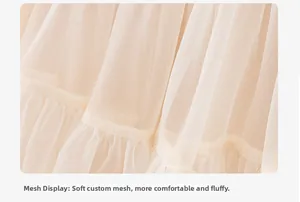 Detailed macro view of soft layered cream tulle fabric on girls princess dress