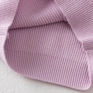Macro shot of lilac purple ribbed knit fabric texture on a soft fluffy background