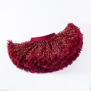 Close-up of burgundy tulle tutu skirt for girls featuring gold star sequins and soft mesh