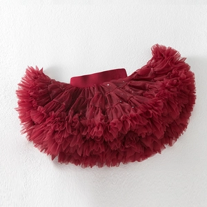 Detail of burgundy layered tutu skirt with shimmering sequins and elastic waistband