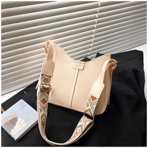 Detail of beige PU leather shoulder bag featuring V-shaped opening and geometric strap