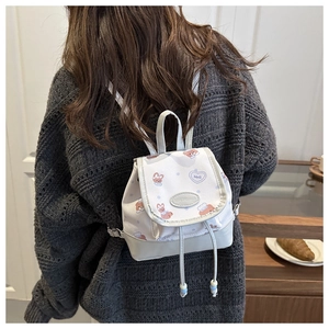 Mini gray backpack with cute bear patterns and a stylish magnetic flap closure on the back