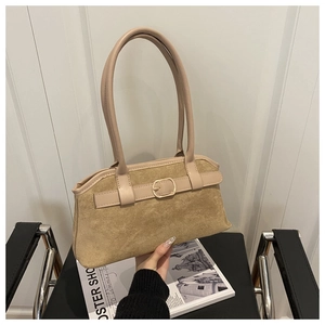 Detail view of suede material and metallic square buckle on this retro apricot shoulder bag