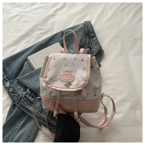 Detail of cute puppy and bear prints on a pink and white sweet girl's backpack