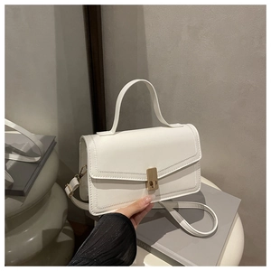 Detail of white PU leather bag with golden twist lock and precise stitching craft