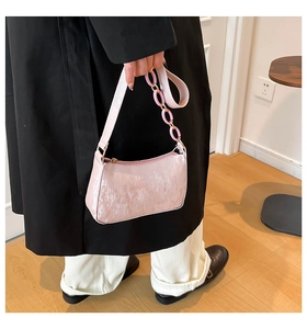 Close-up of pink glittery shoulder bag with matching thick plastic chain and strap