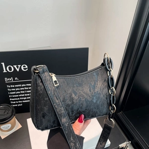 Fashionable black faux leather underarm bag with gold chain and vintage texture
