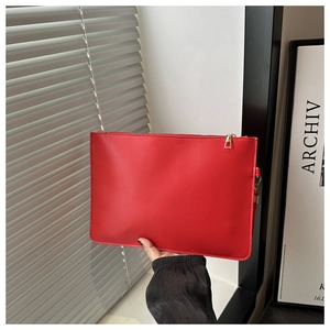 Detailed close-up of a red rectangular PU leather envelope clutch bag with gold zipper