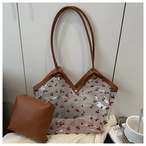Detail view of transparent PVC cherry print tote with inner brown PU leather pouch set