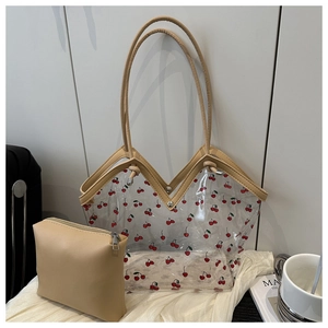Detailed view of clear PVC tote with cherry print and beige leather inner pouch bag