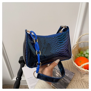 Detail of blue gradient snakeskin texture handbag with thick blue chain strap and zipper